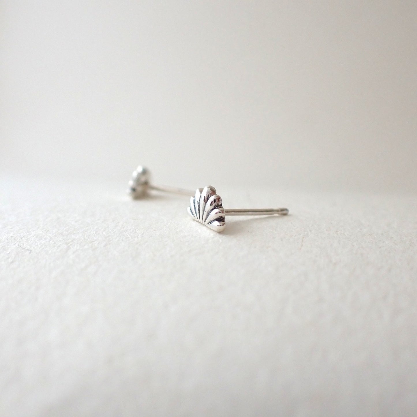 side view of handmade lotus flower earrings to show depth of metal used (i.e. 3D design, not thin)
