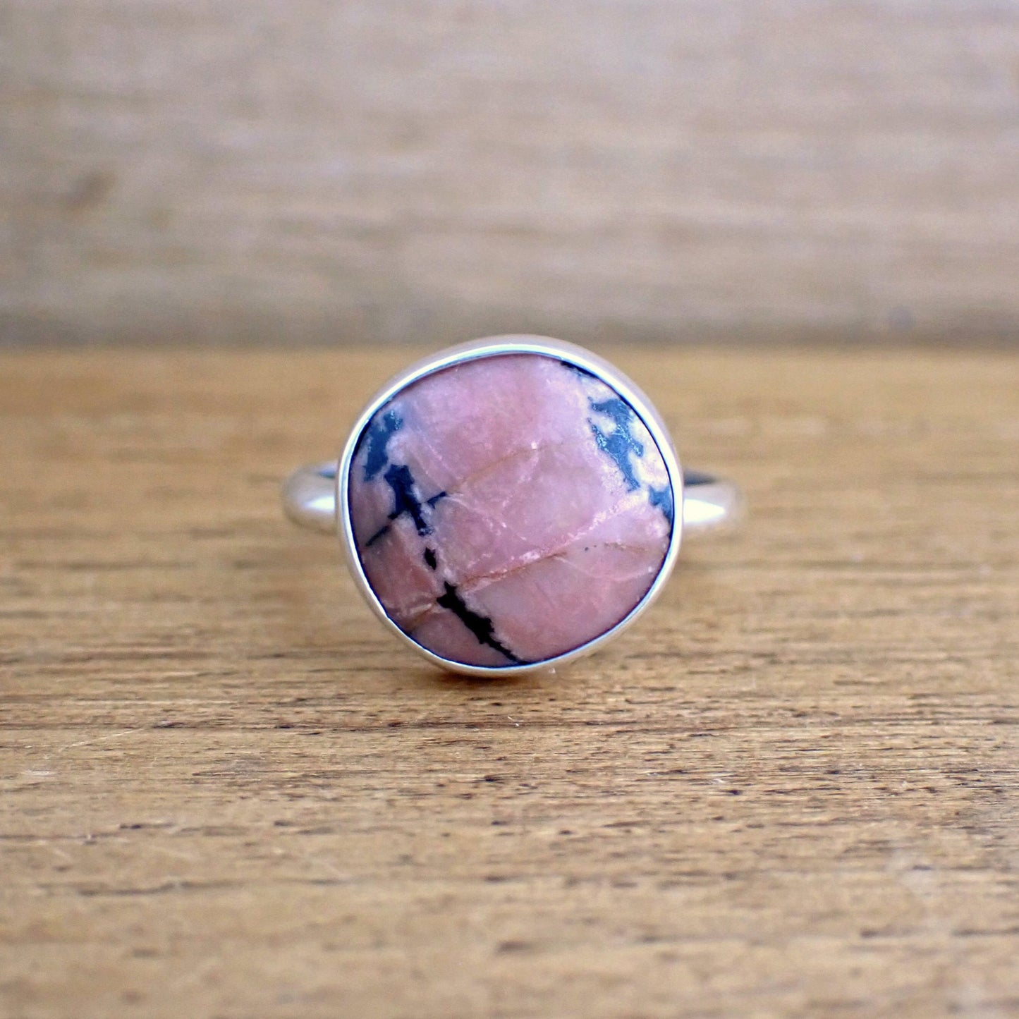 a face on view of the Bloom II ring to show the black and white streaks across the pink stone