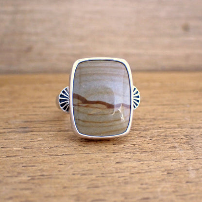 A face on view of the Roam ring which shows the two decorative stamped shoulders are set either side of the centre of the stone on the band of the ring
