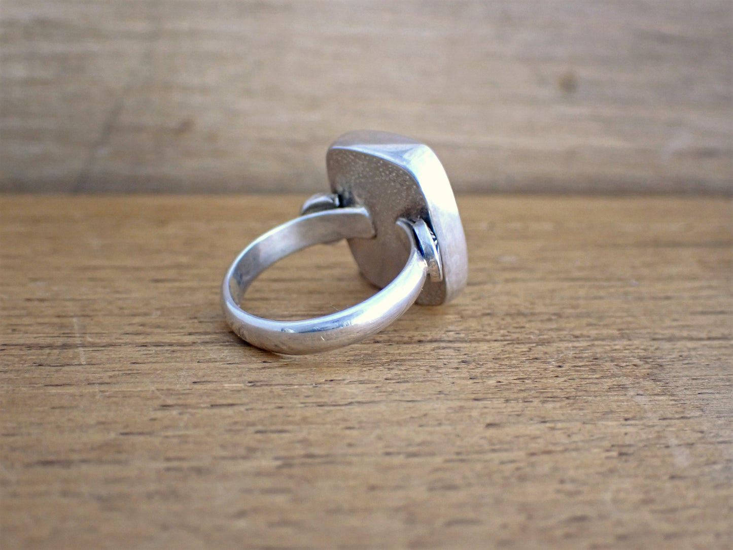 back view of the Roam ring to show the back of the bezel set stone is engraved with little dots. This photo also shows the ring has been constructed from scratch (not cast in a factory!)