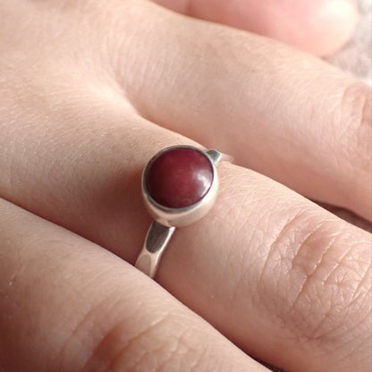 a worn shot of the Cherry Drop ring to show it has a slim band and is quite dainty on the finger